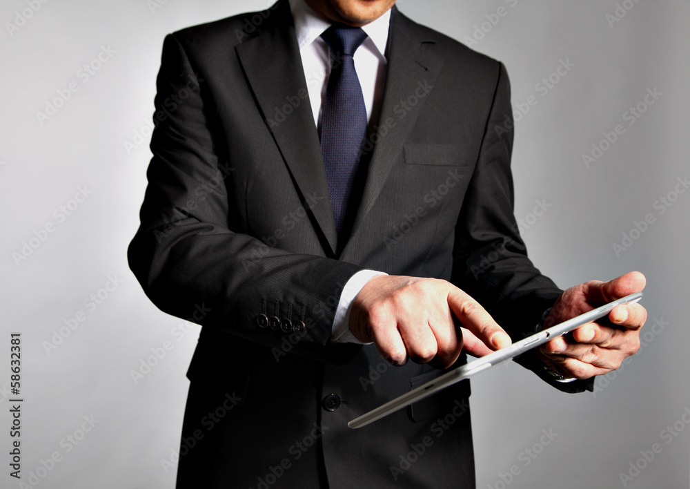 Bisnessman holds a table pc