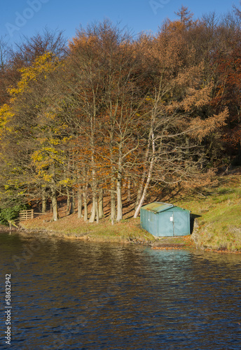 wooden fishing boat hut in autumn landscape