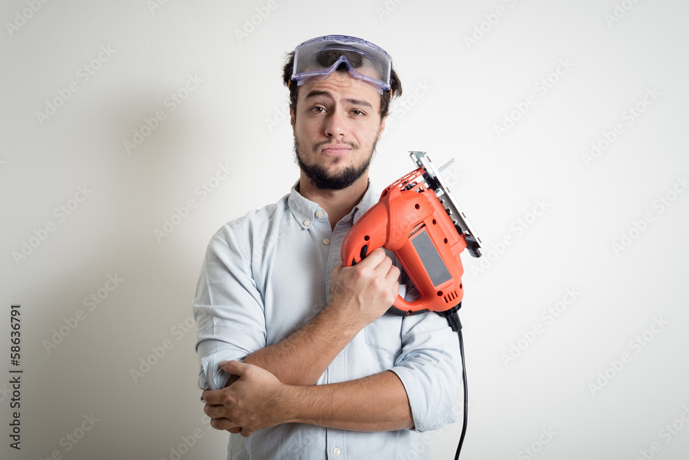 young man bricolage working with electric saw young man bricolage working with electric saw