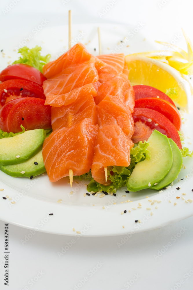 raw salmon fillet on sticks with vegetables