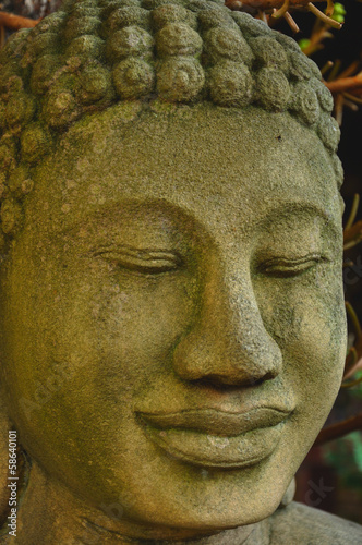 Face of old Buddha statue