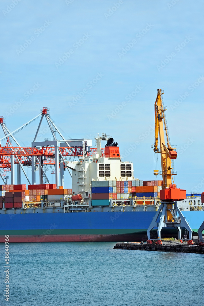 Fototapeta premium Container stack and ship under crane bridge