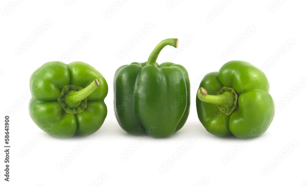 Three fresh green bell peppers isolated in a row close up Three fresh green bell peppers isolated in a row close up
