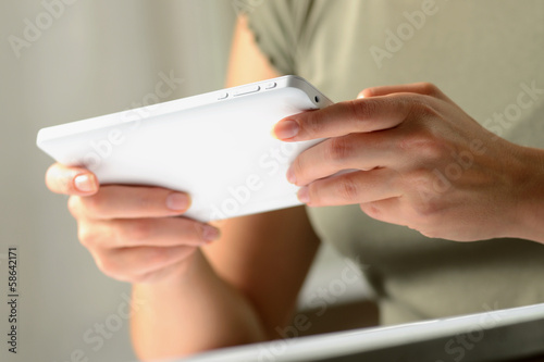 Hands of a man using a PC tablet, from low angle