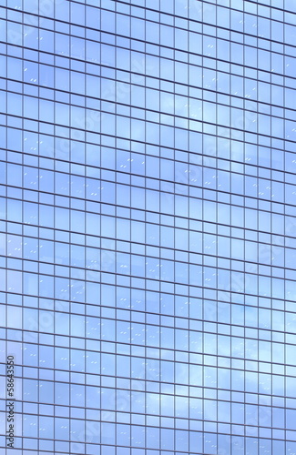 Sky and clouds reflected in a modern building glass facade