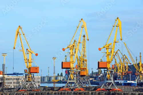 Port cargo crane over blue sky background