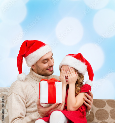 smiling daughter waiting for a present from father