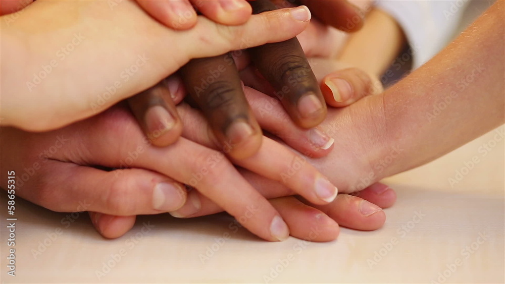 Teenager stacking hands for teamwork