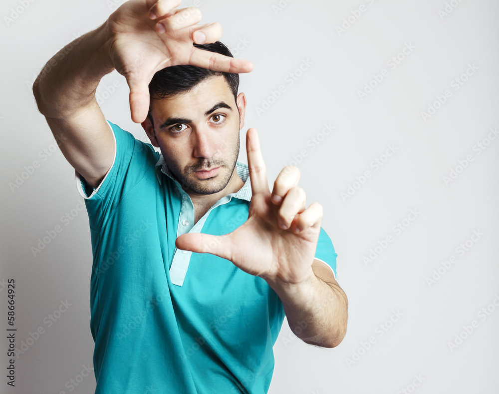 Fototapeta premium Caucasian male making photo frame with his hands