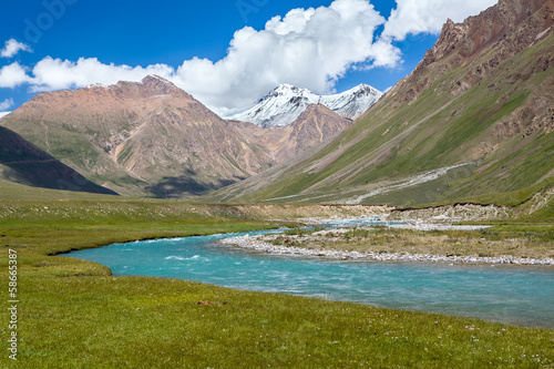 Blue river and snow peaks of Tien Shan mountains