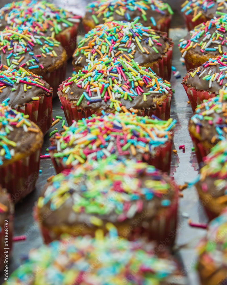 Line of cupcakes with sprinkles