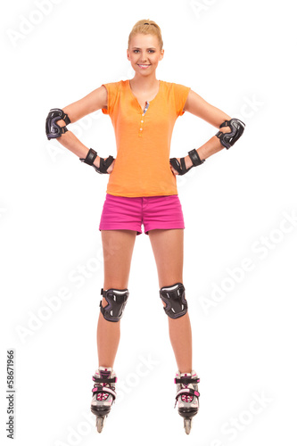Smiling Woman on rollerblades wearing kneepad and elbow pad.