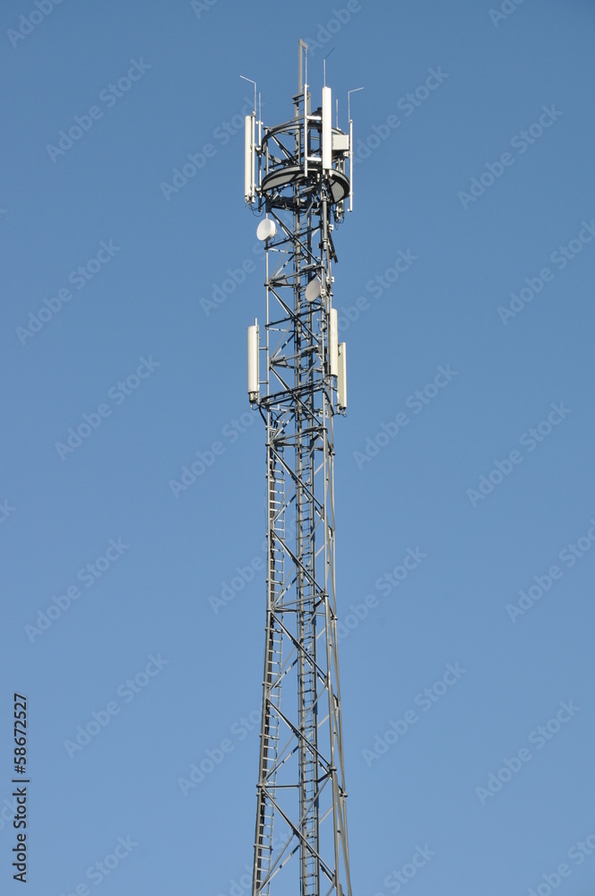 Telecommunication tower against the blue sky 