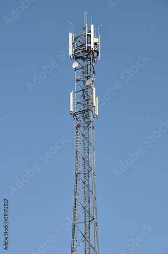 Telecommunication tower against the blue sky 