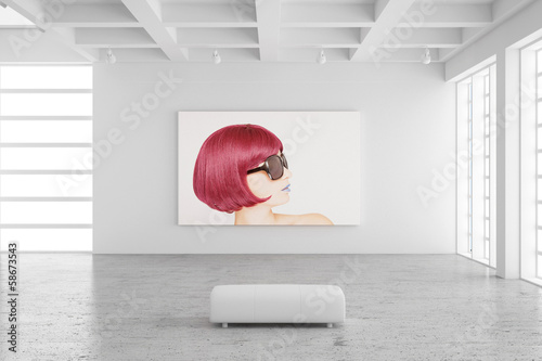 Empty exhibition hall with picture of a woman photo