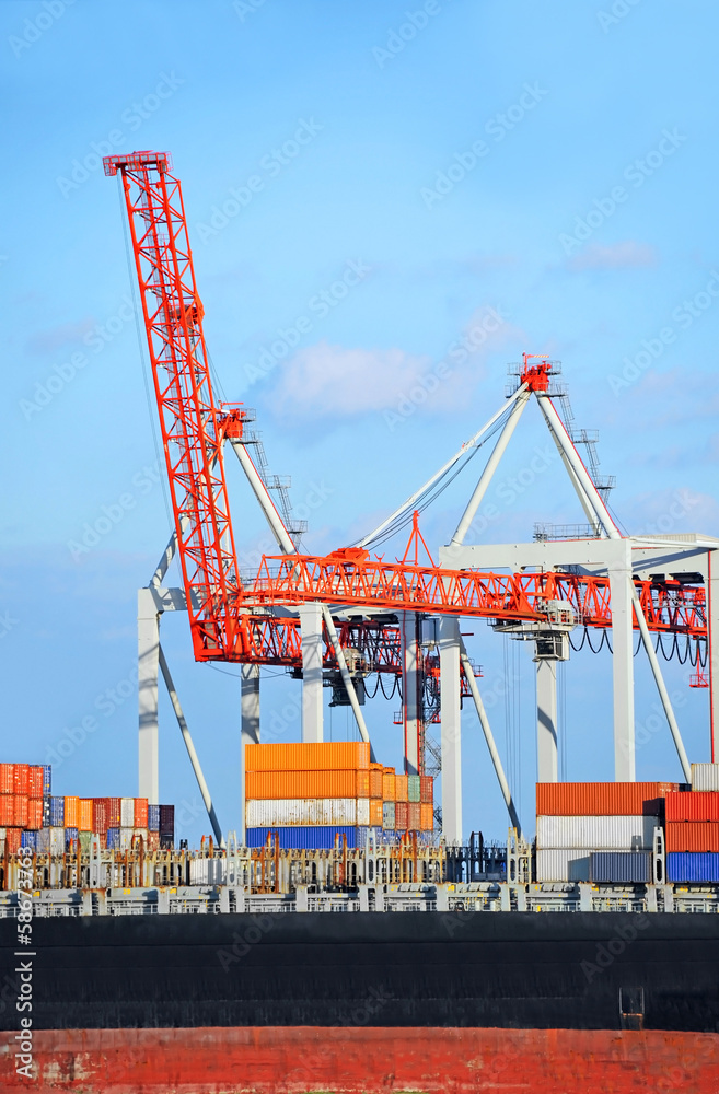 Container stack and ship under crane bridge Container stack and ship under crane bridge
