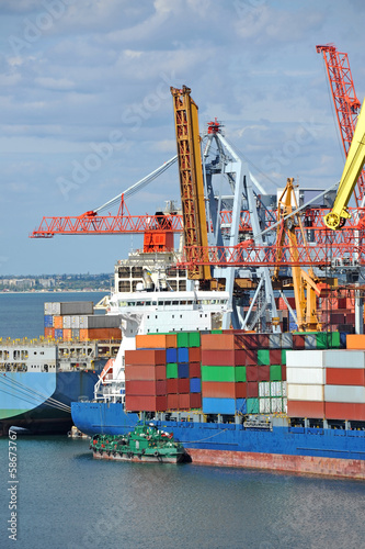 Container stack and ship under crane bridge