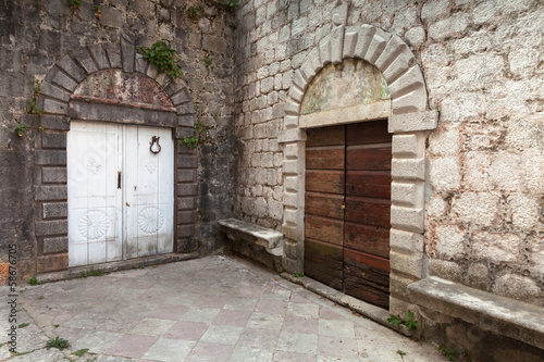 Wooden doors on the street of ancient Perast town  Kotor bay  Mo