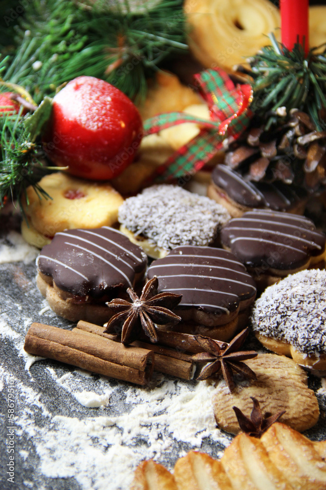 Mix of Christmas cookies with cinnamon and candle Mix of Christmas cookies with cinnamon and candle
