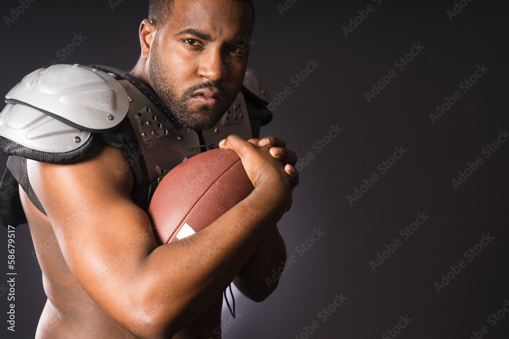 Angry African American Male Football Player Holds Ball Tight Angry African American Male Football Player Holds Ball Tight