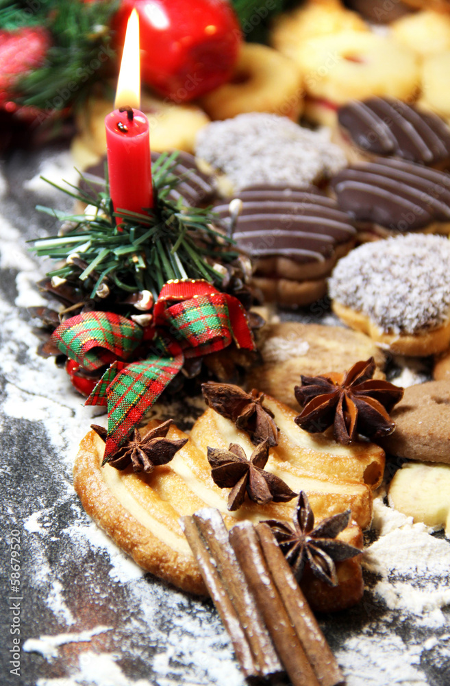 Mix of Christmas cookies with cinnamon and candle Mix of Christmas cookies with cinnamon and candle
