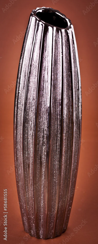 Modern clay vase on brown background