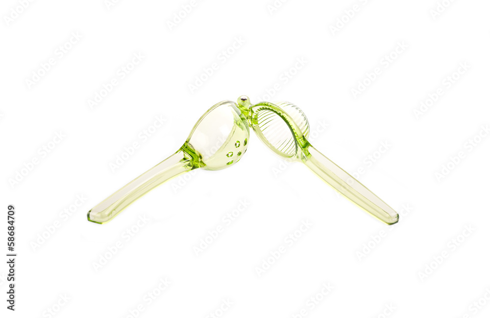 shiny plastic garlic press isolated against white background. shiny plastic garlic press isolated against white background.