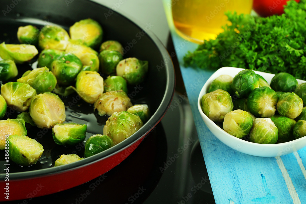 Fresh brussels sprouts in pan on cooking surface close-up Fresh brussels sprouts in pan on cooking surface close-up
