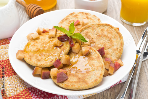 homemade pancakes with peaches and honey, top view