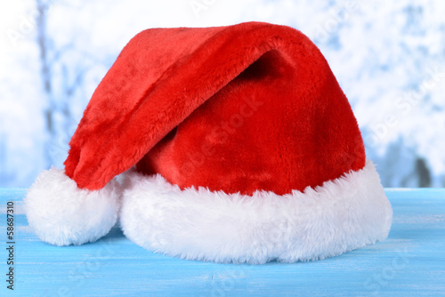Christmas hat on table on light background