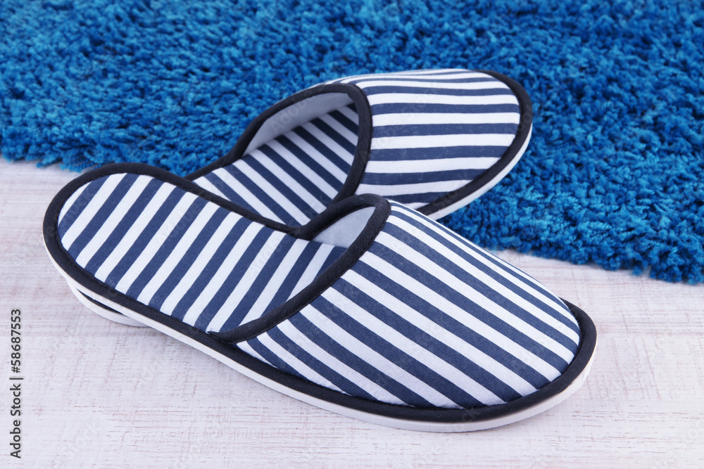 Striped slippers on floor background Striped slippers on floor background