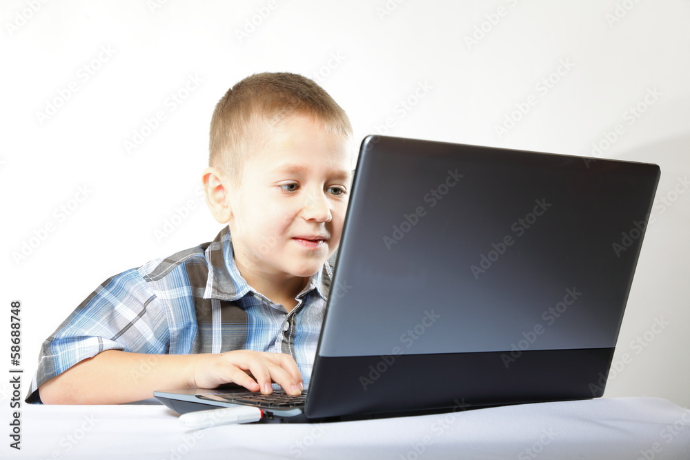Computer addiction child with laptop notebook Computer addiction child with laptop notebook