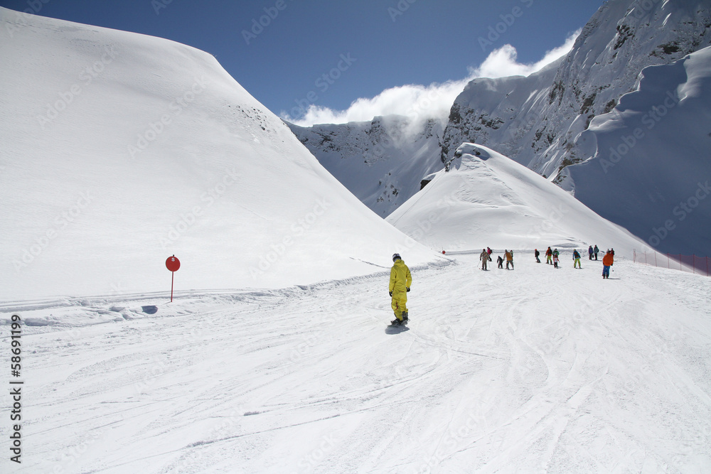 Skiers going down the slope at ski resort