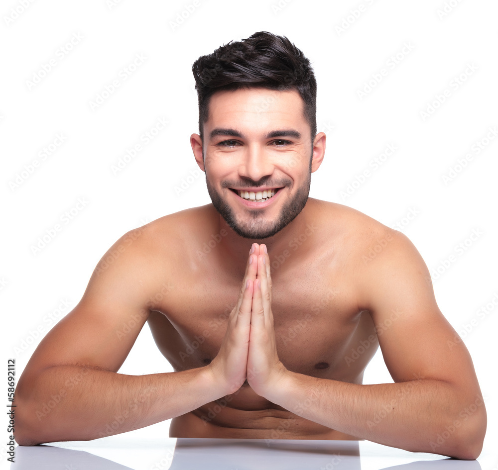 Fototapeta premium young smiling man is praying