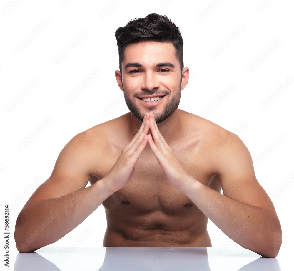 Fototapeta premium young naked beauty man making a house with his hands