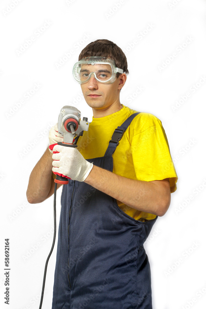 Isolate Man in yellow shirt coveralls with the drill Isolate Man in yellow shirt coveralls with the drill