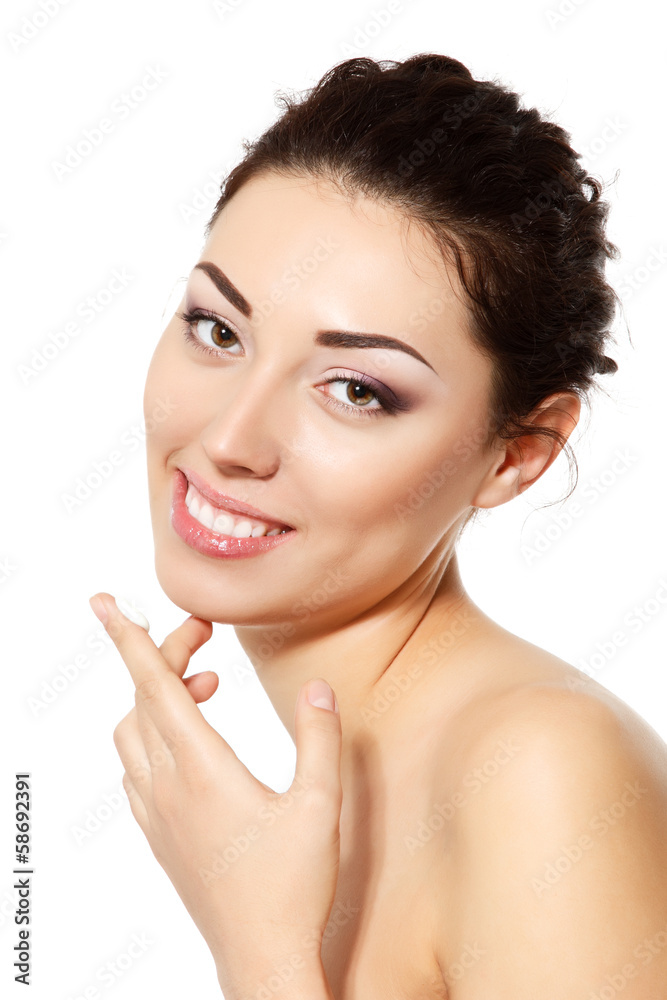 young woman applying ceam on face, over white young woman applying ceam on face, over white