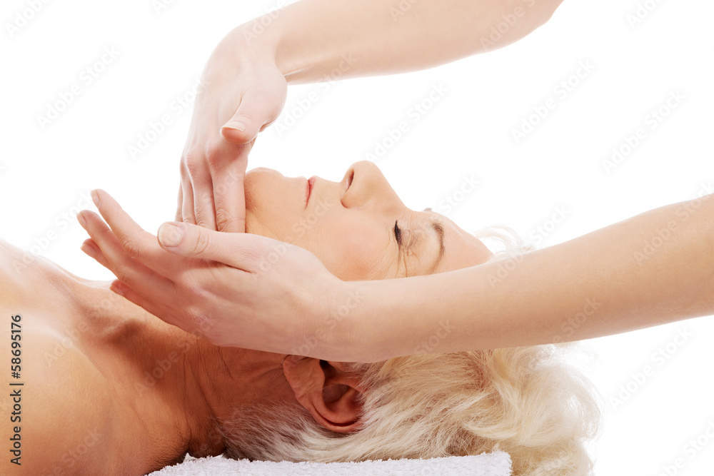 Fototapeta premium An old woman is having a massage. Spa concept.