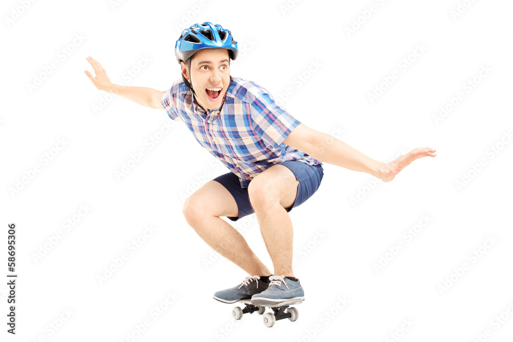 Smiling guy with helmet skating on a skate board
