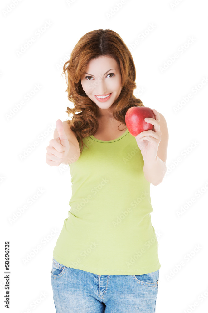 Attractive casual woman holding an apple. Attractive casual woman holding an apple.