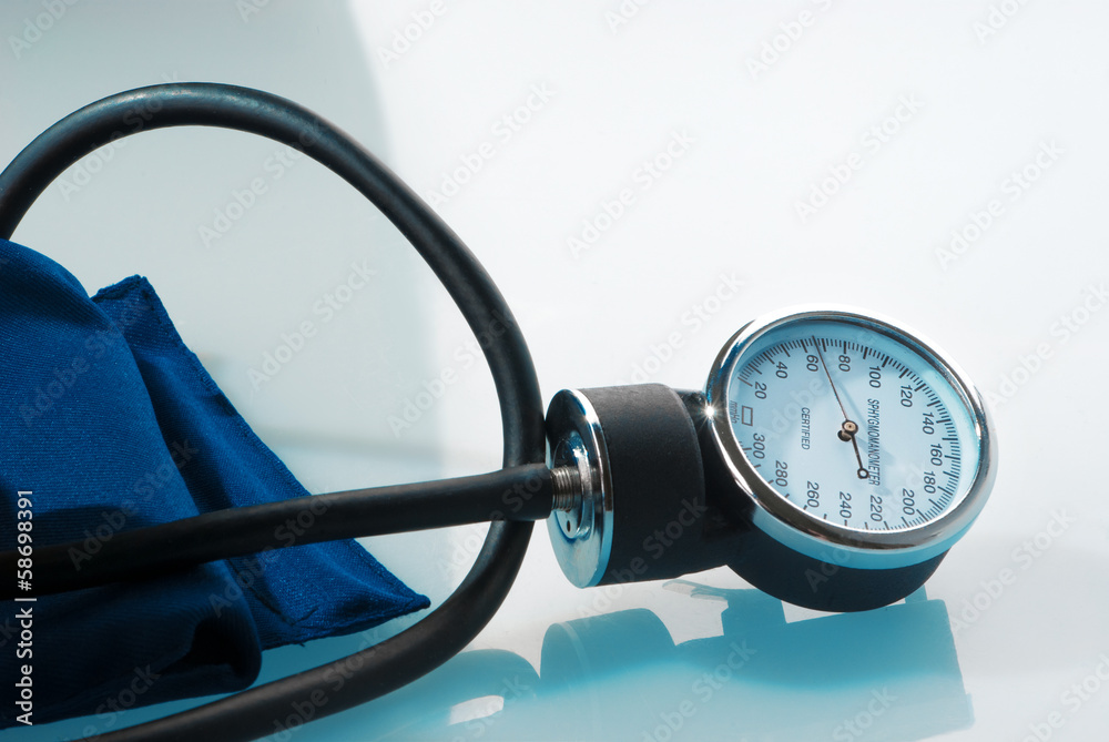 Sphygmomanometer on blue, reflective background Sphygmomanometer on blue, reflective background