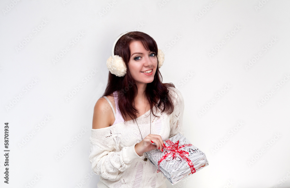 Smiling girl opening a present on white background Smiling girl opening a present on white background