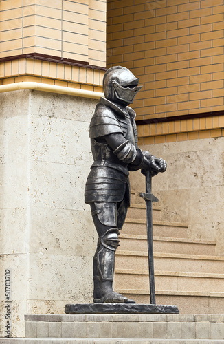 Knight in armor with a sword.