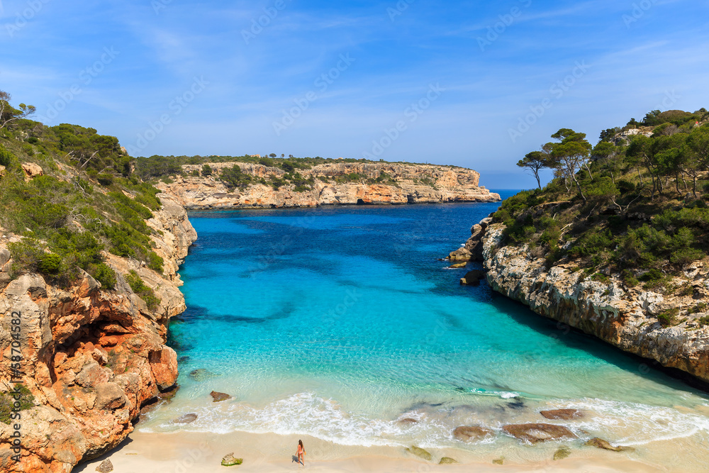 Fototapeta premium Unidentified young woman on beach, Cala des Moro, Majorca