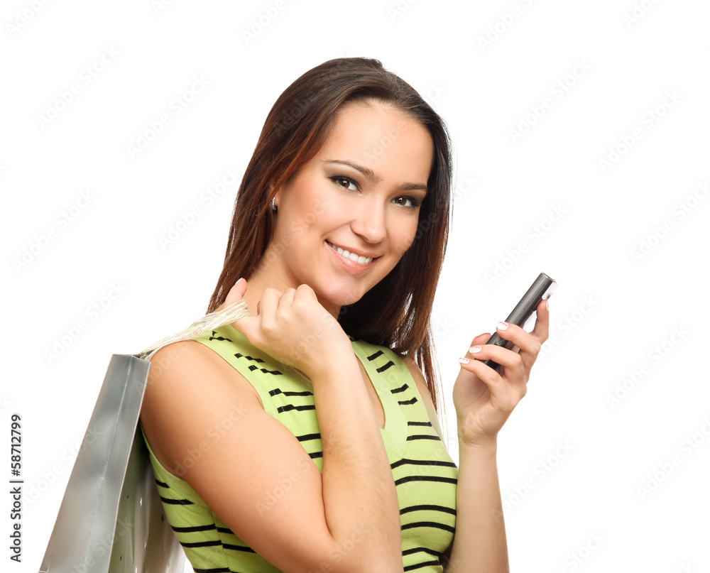 Girl calling by mobile phone with shopping bags. Girl calling by mobile phone with shopping bags.