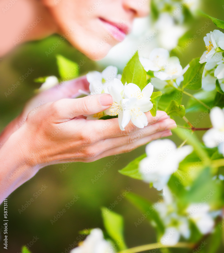 Woman face near blooming tree