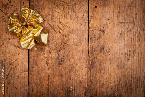 Small golden ribbon on wooden background