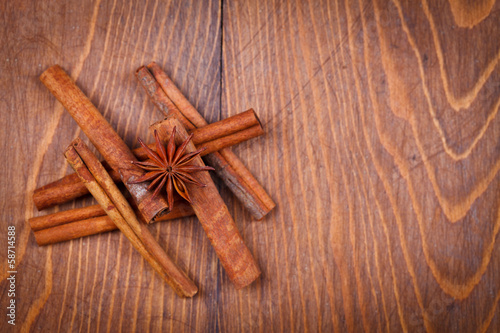 Cinnamon and star anise on wooden background