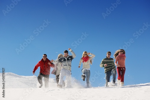 friends have fun at winter on fresh snow