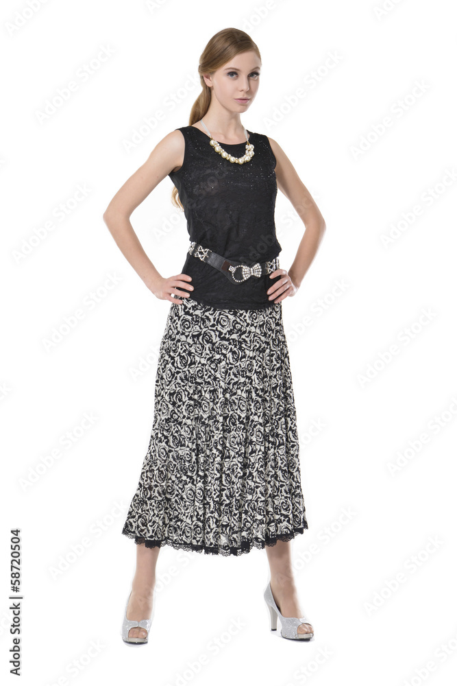 portrait of trendy young woman in elegant dress posing